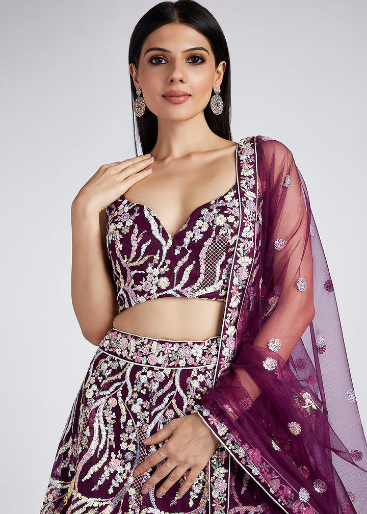 Beautiful model wearing the Tyrian Purple Net Lehenga Choli With Sequins & Thread Embroidery Work with matching accessories