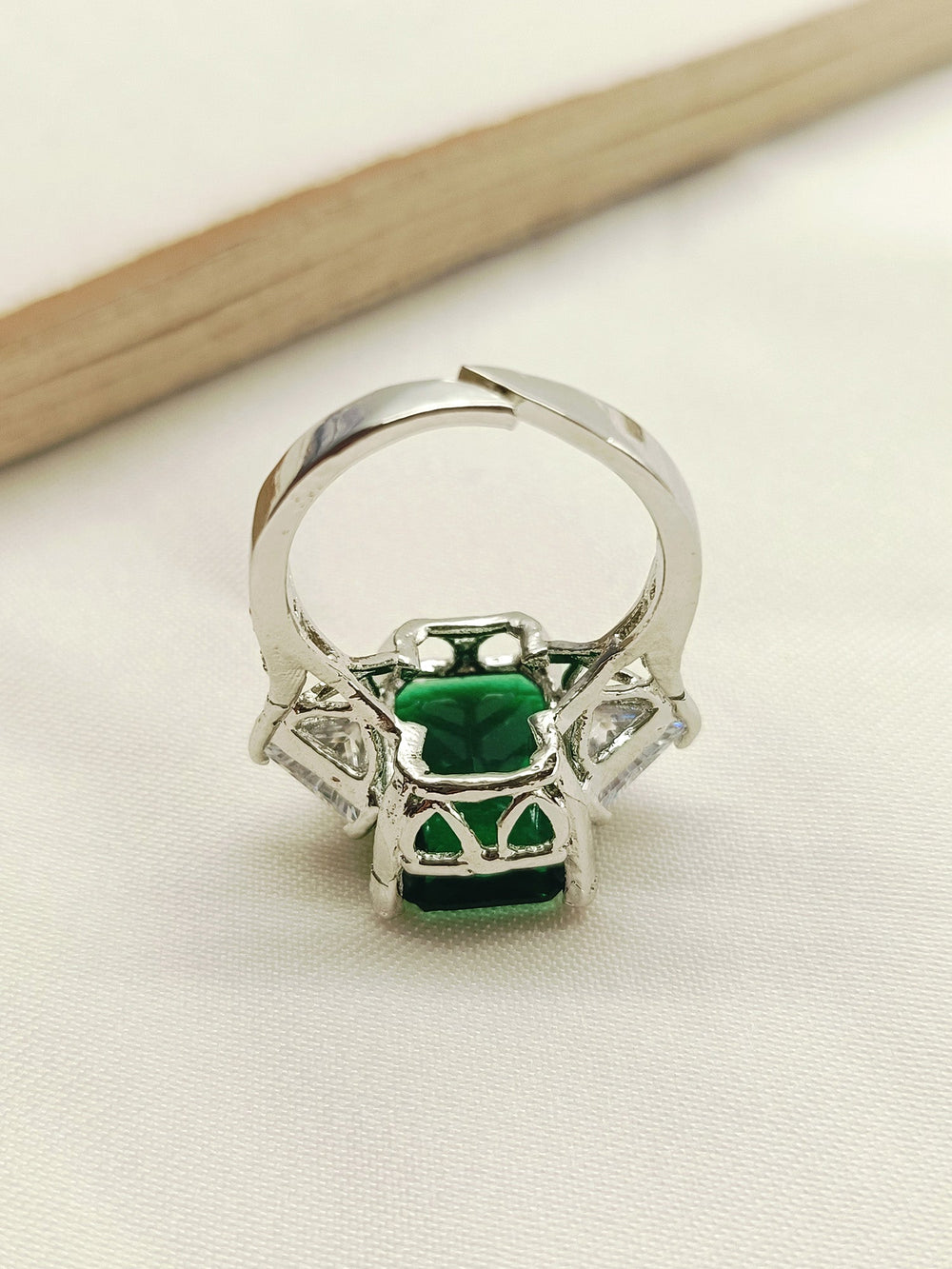 This Mehar Green American Diamond Finger Ring is a luxurious and eye-catching accessory that exudes sophistication and style, making it the perfect statement piece for any special occasion or everyday wear