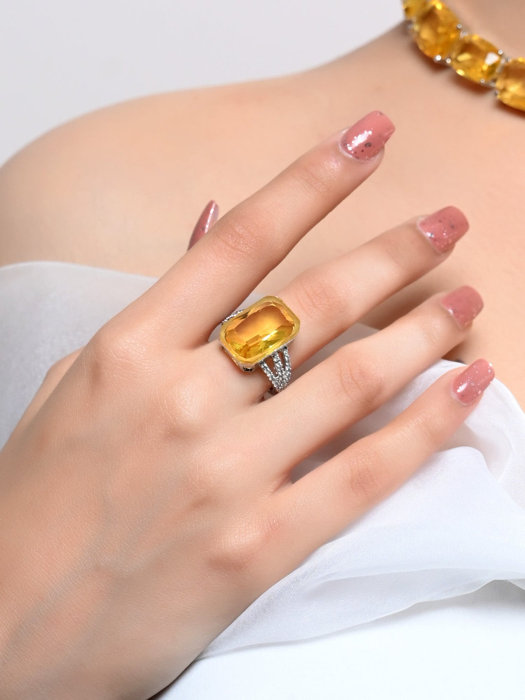 Shimmering Lucy Yellow American Diamond Finger Ring on a woman's hand