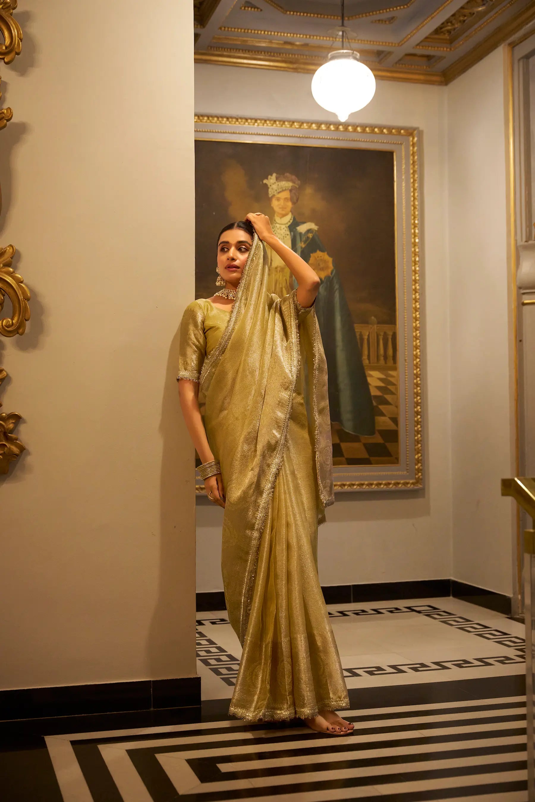 Golden Shimmer Tissue Saree With Zari Weaving Work & Sequins Lace Border