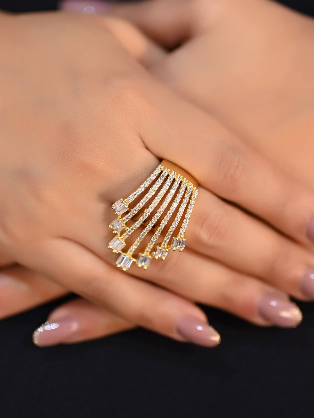 Beautiful Naveena Golden Tone American Diamond Finger Ring on a woman's hand, shining in the light