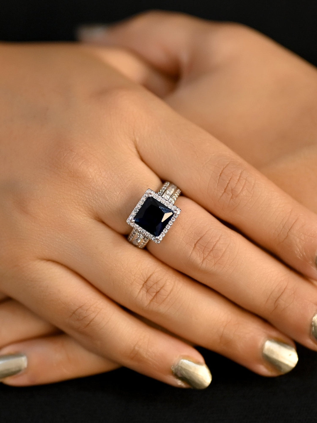  Close-up of Sufiana Navy Blue American Diamond Finger Ring on woman's finger