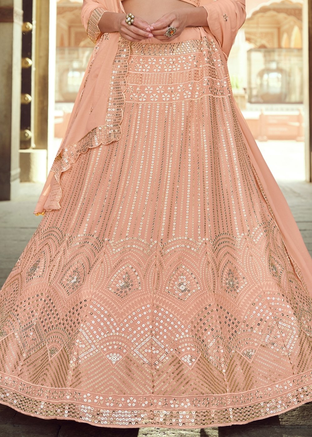 Peach pink georgette lehenga choli with intricate sequins and thread work embroidery