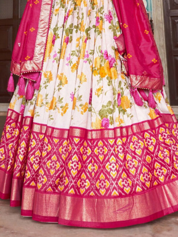 Traditional Indian outfit featuring pink lehenga choli with floral and patola print