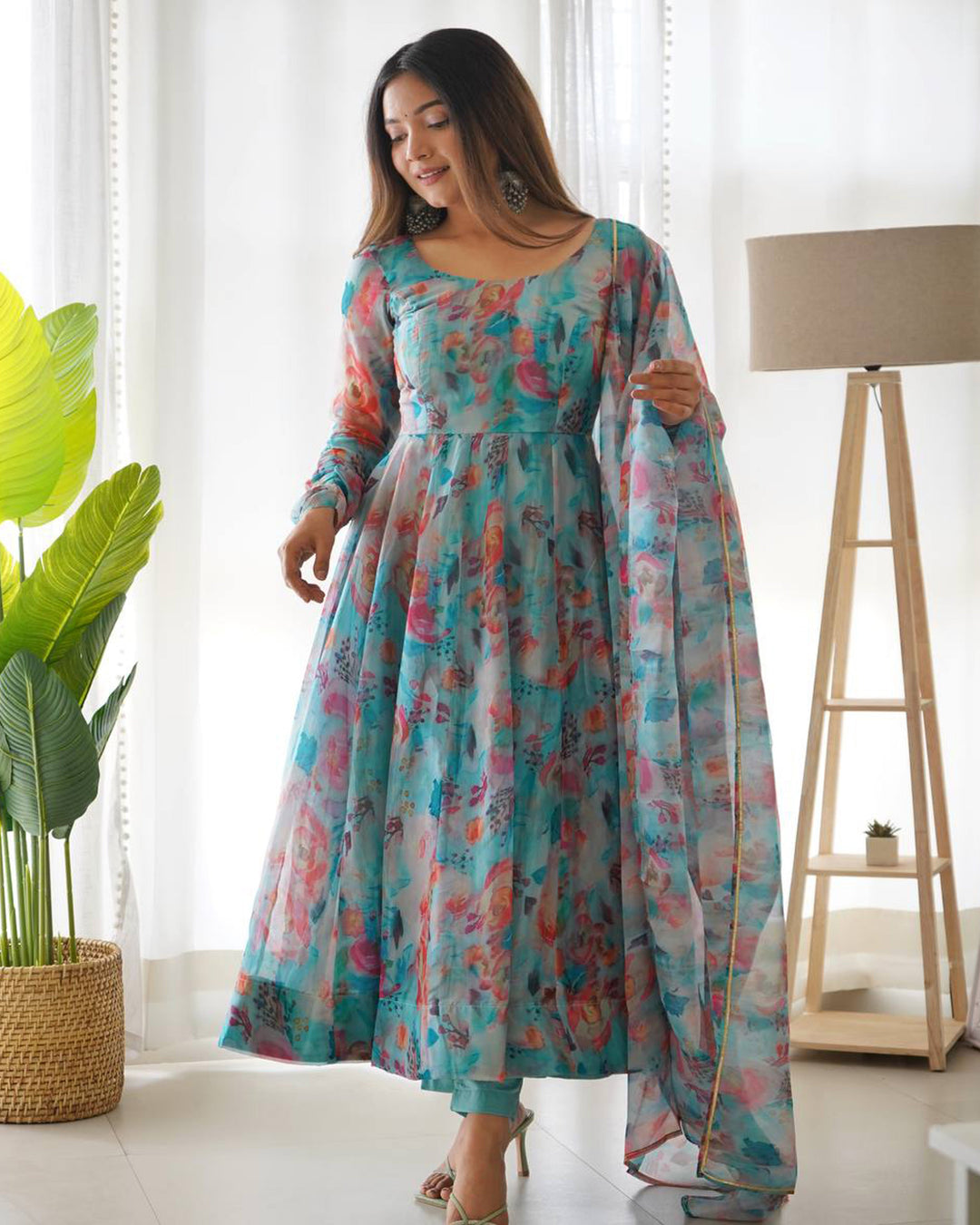 Sky blue multi color print organza three piece anarkali suit by Qivii features a flowing floor-length silhouette with intricate detailing and a stunning combination of colors