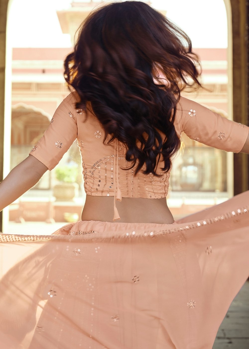 Gorgeous side view of the Peach Pink Georgette Lehenga Choli with Sequins & Thread work, demonstrating the flowing fabric and elegant design