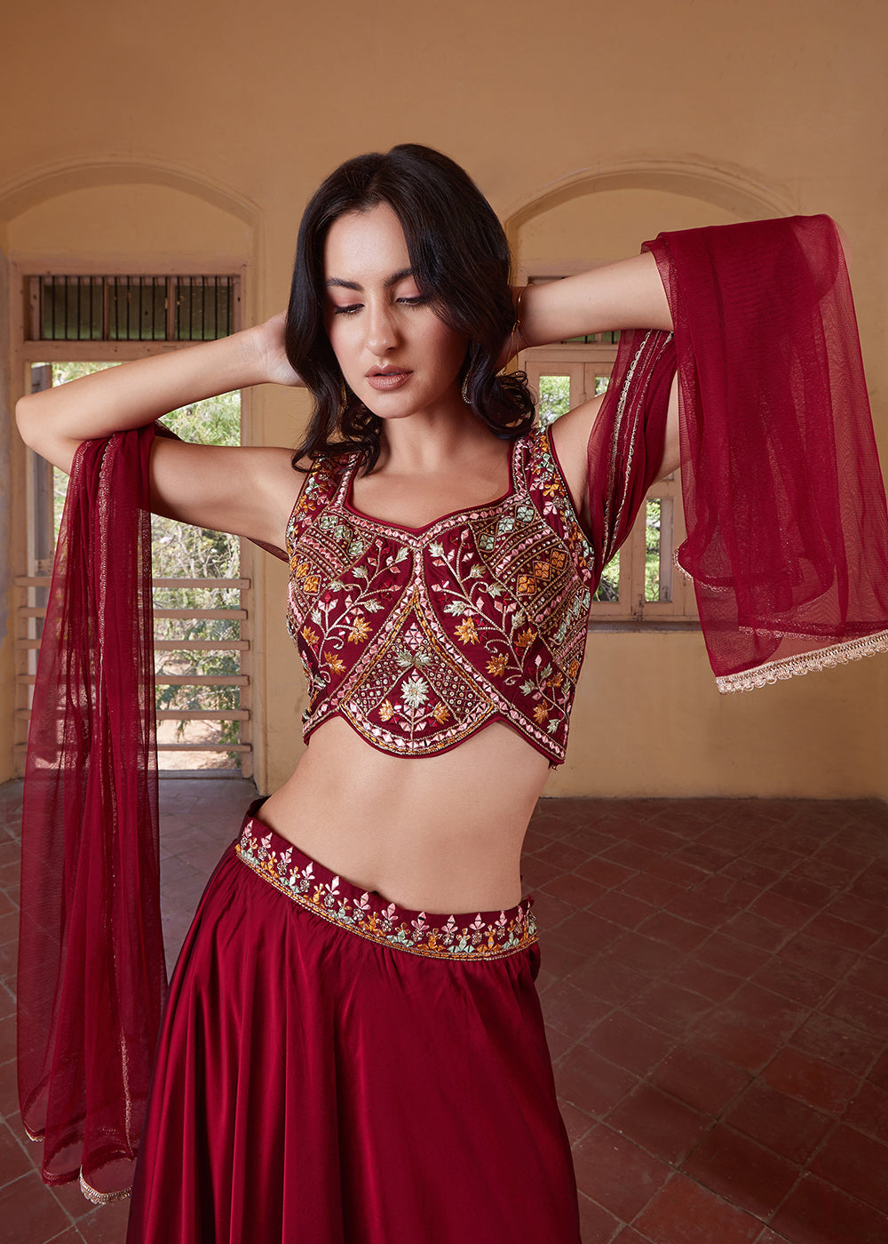 Elegant maroon designer lehenga choli with crop top style and intricate detailing