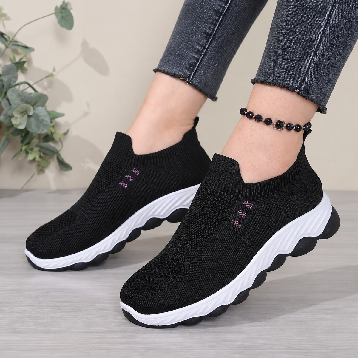 Black women's Avenleigh knit slip-on sneakers by Bootara featuring breathable mesh and round toe casual design.