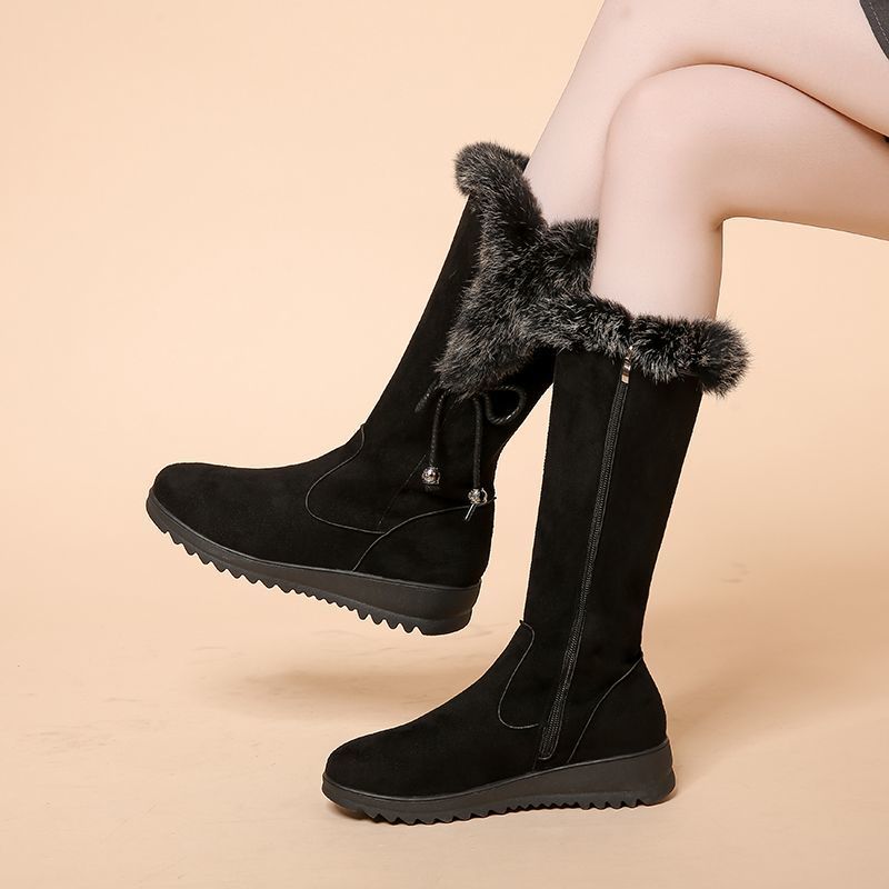 Black women's Elowick tall winter boots by Bootara with fur cuff, side zipper, and wedge lug sole, available in US sizes 4 to 9.