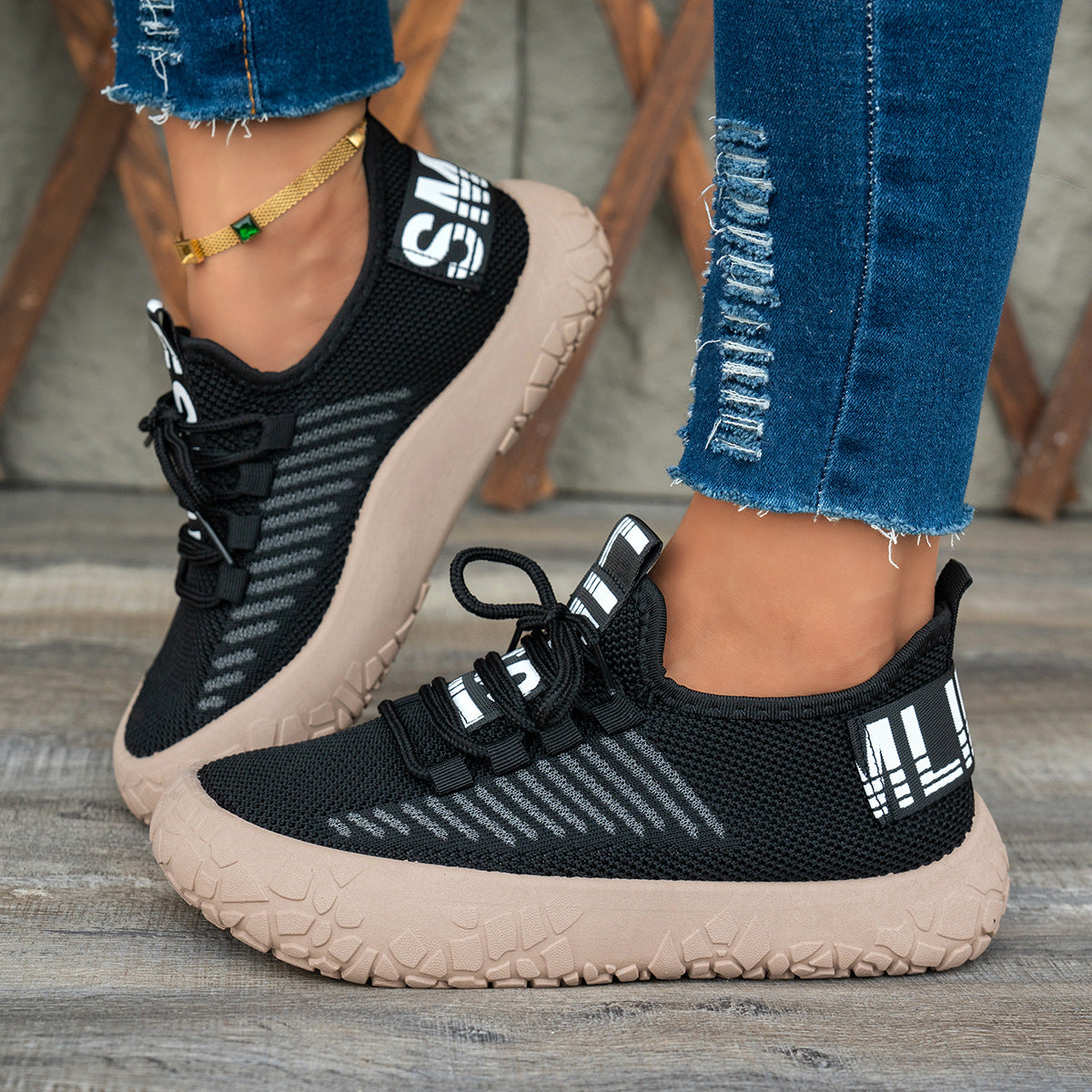 Black women's Kestielle knit sneakers by Bootara with slip-on design, laces, and chunky textured sole, available in US sizes 5 to 10.5.