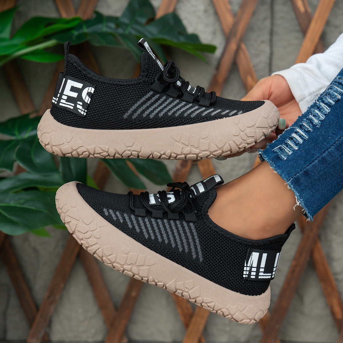 Black women's Kestielle Knit sneakers by Bootara with breathable slip-on design, laces, and chunky textured sole, US size 5-10.5.