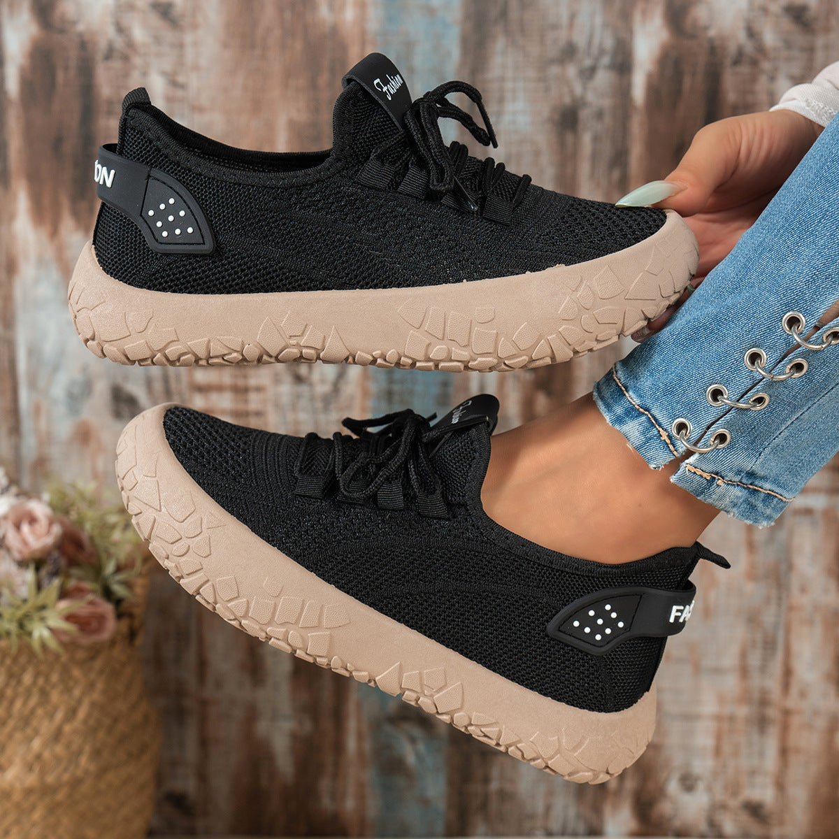Black women's Thessalie Knit Sneakers by Bootara featuring breathable slip-on design, laces, and textured chunky sole.