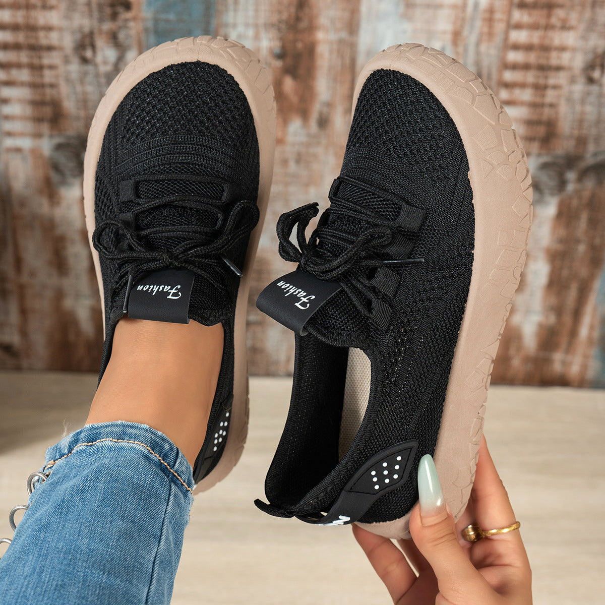Black women's Thessalie Knit Sneakers by Bootara with breathable slip-on design, laces, and textured chunky sole.