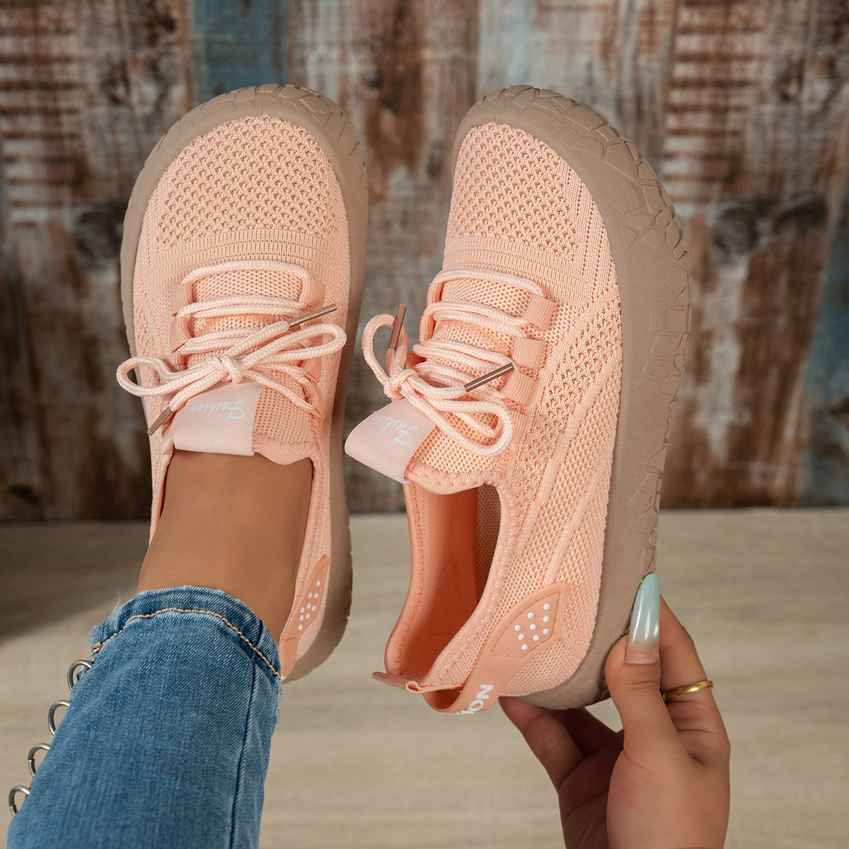 Women’s Thessalie Knit Sneakers by Bootara, breathable slip-on shoes with laces and textured chunky sole in orange.