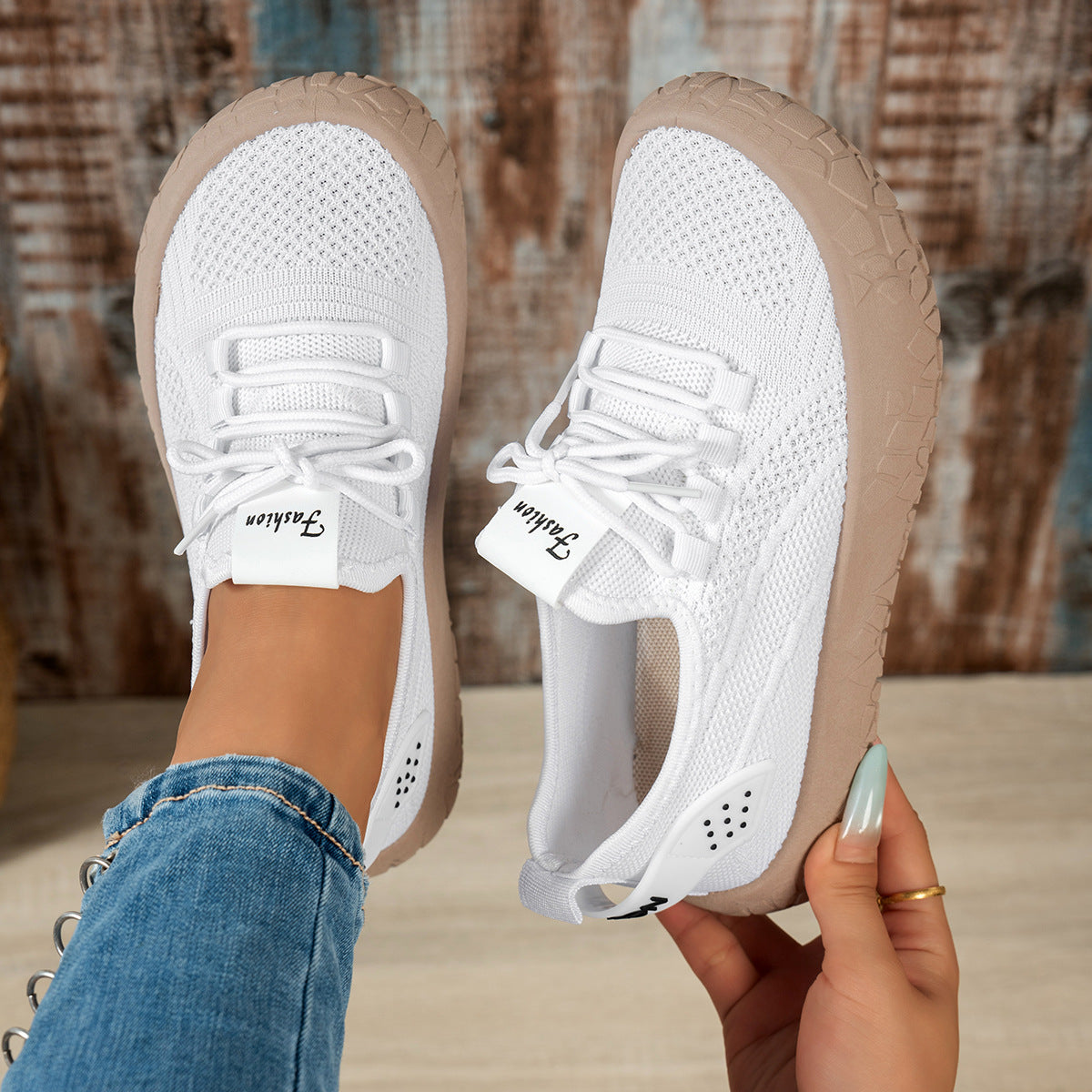 White women's Thessalie Knit Sneakers by Bootara with breathable slip-on design, laces, and textured chunky sole, US size 7.