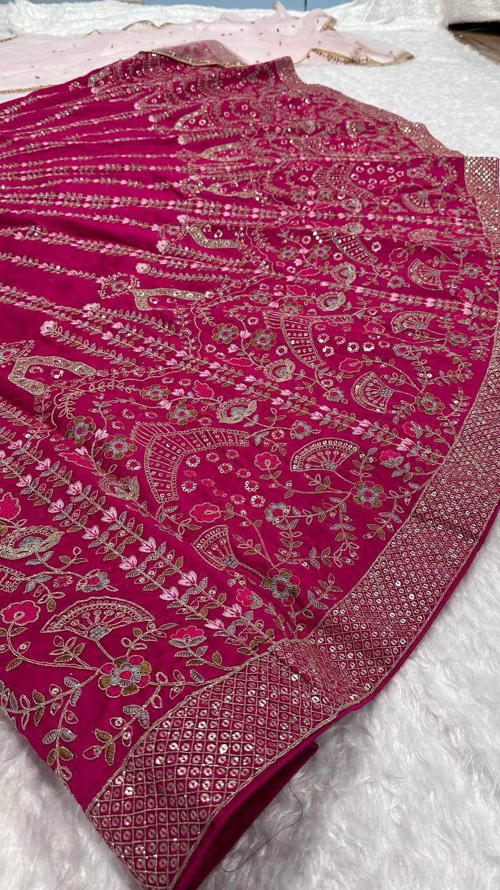 Close-up of the delicate thread work on the pink lehenga flare