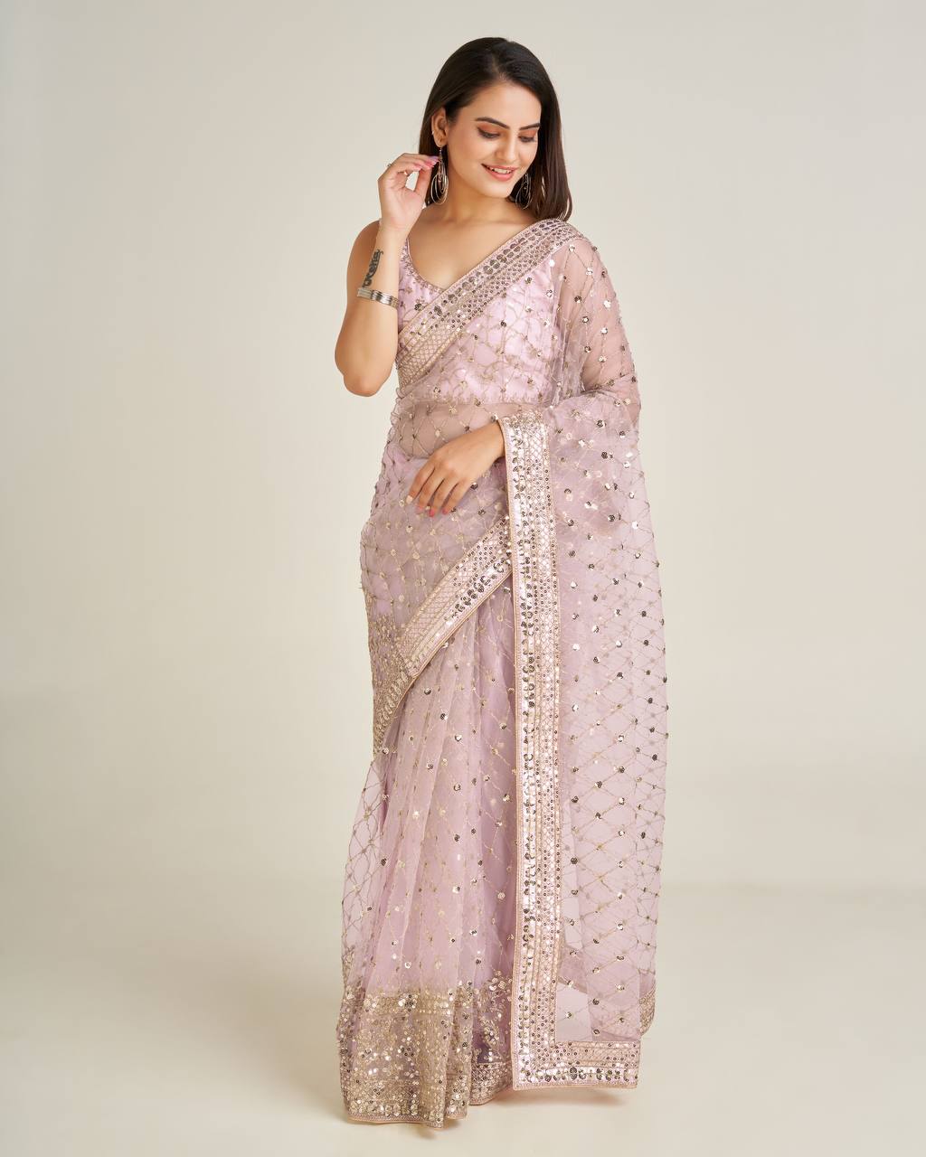 Beautiful pink net saree with intricate sequins and dori work details