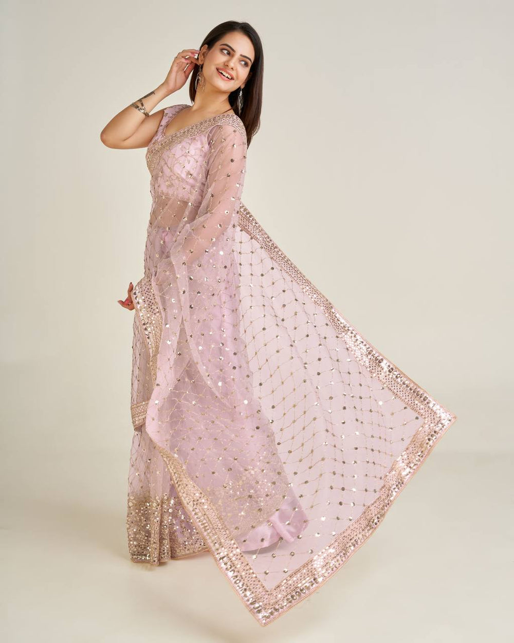 Beautiful pink net saree with intricate sequins and dori work details