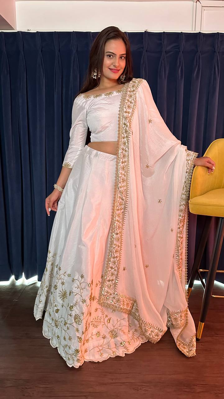 Beautifully crafted white silk lehenga with elegant zari and sequins work