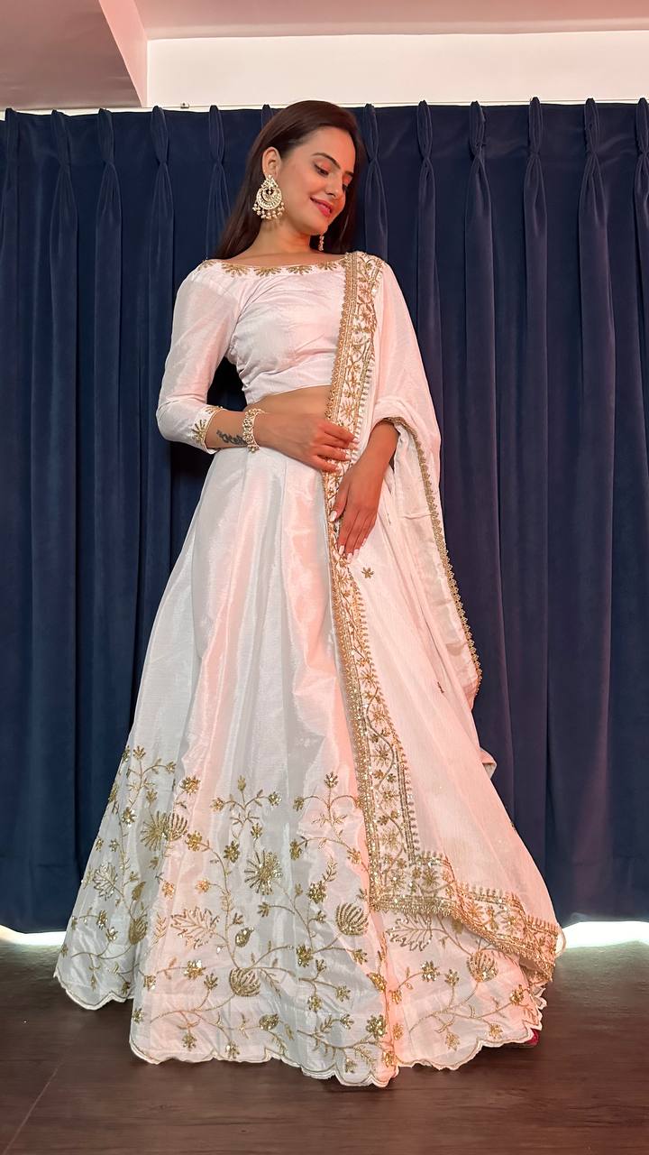 Exquisite white slub silk lehenga with stunning zari and sequins embellishments