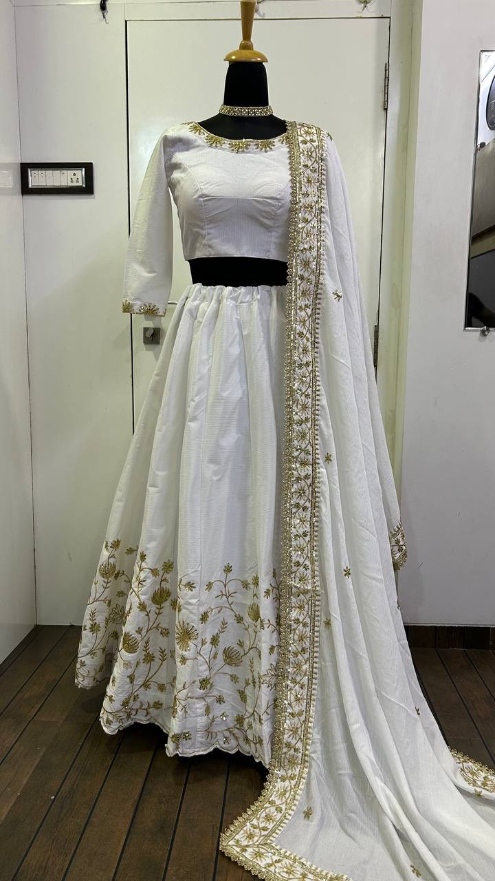 Premium slub silk lehenga in white color featuring exquisite zari and sequins detailing