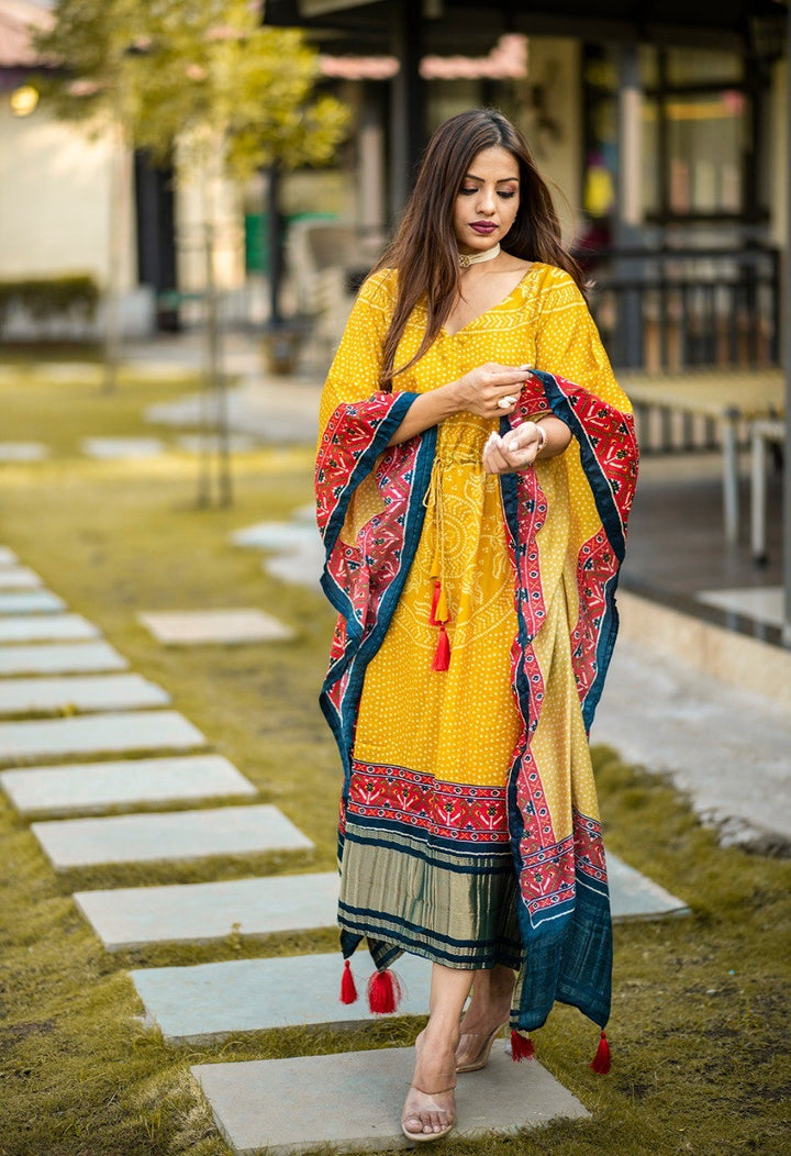 Mustard Pure Gaji Silk Digital Print with Gotta Patti Lace Border also comes with tassels Kaftan Dress showcasing elegant and intricate design details for a sophisticated and stylish look