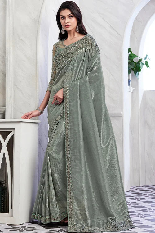 Women wearing elegant greenish grey blouse with a cocktail party saree 