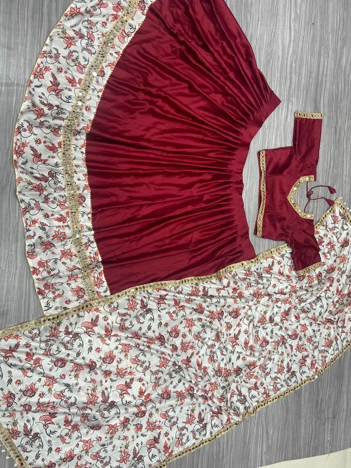 Luxurious maroon malai satin silk adorned with elaborate digital print and heavy real mirror work