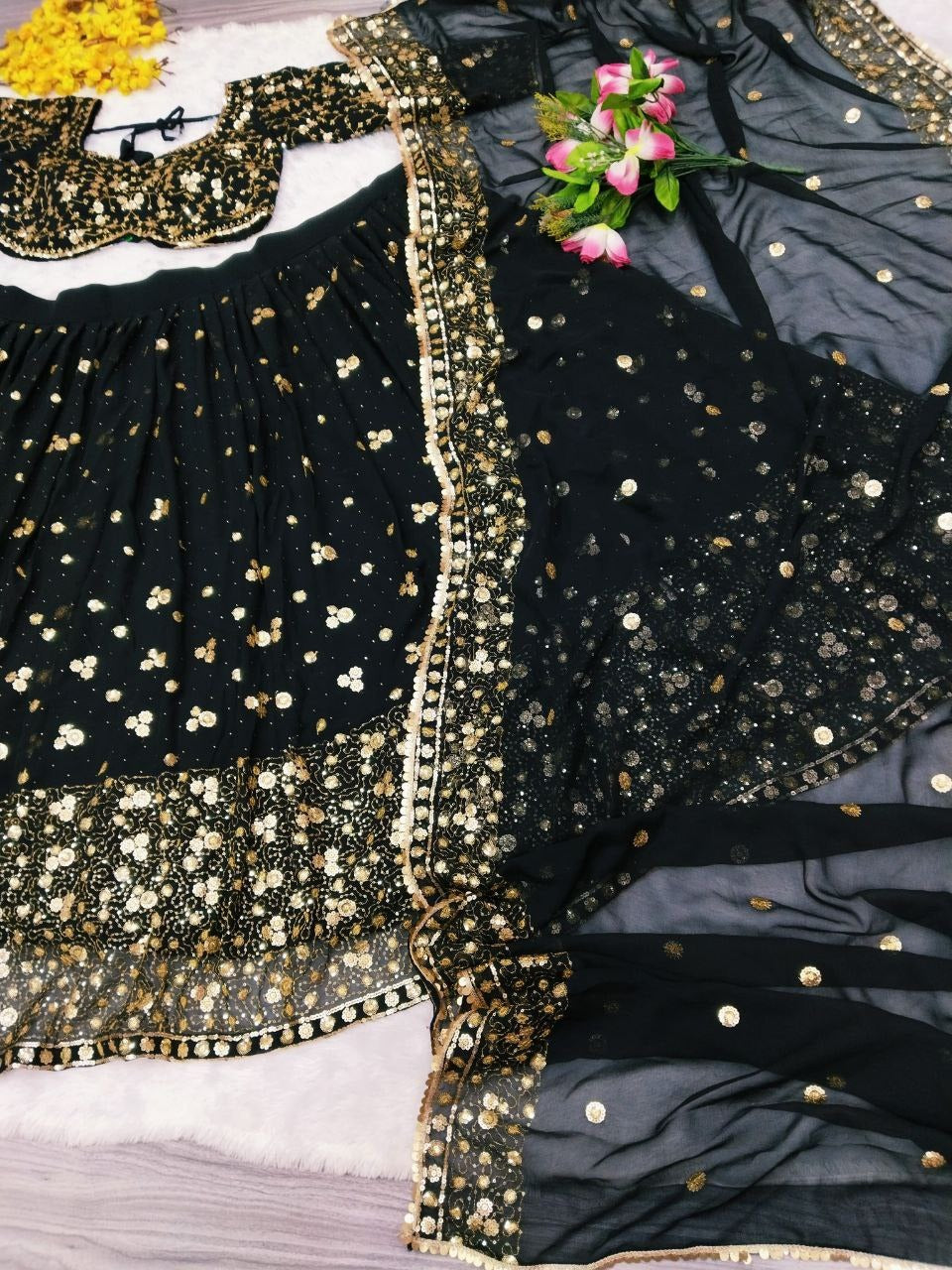 Close-up of the embellished detailing on the premium georgette black lehenga