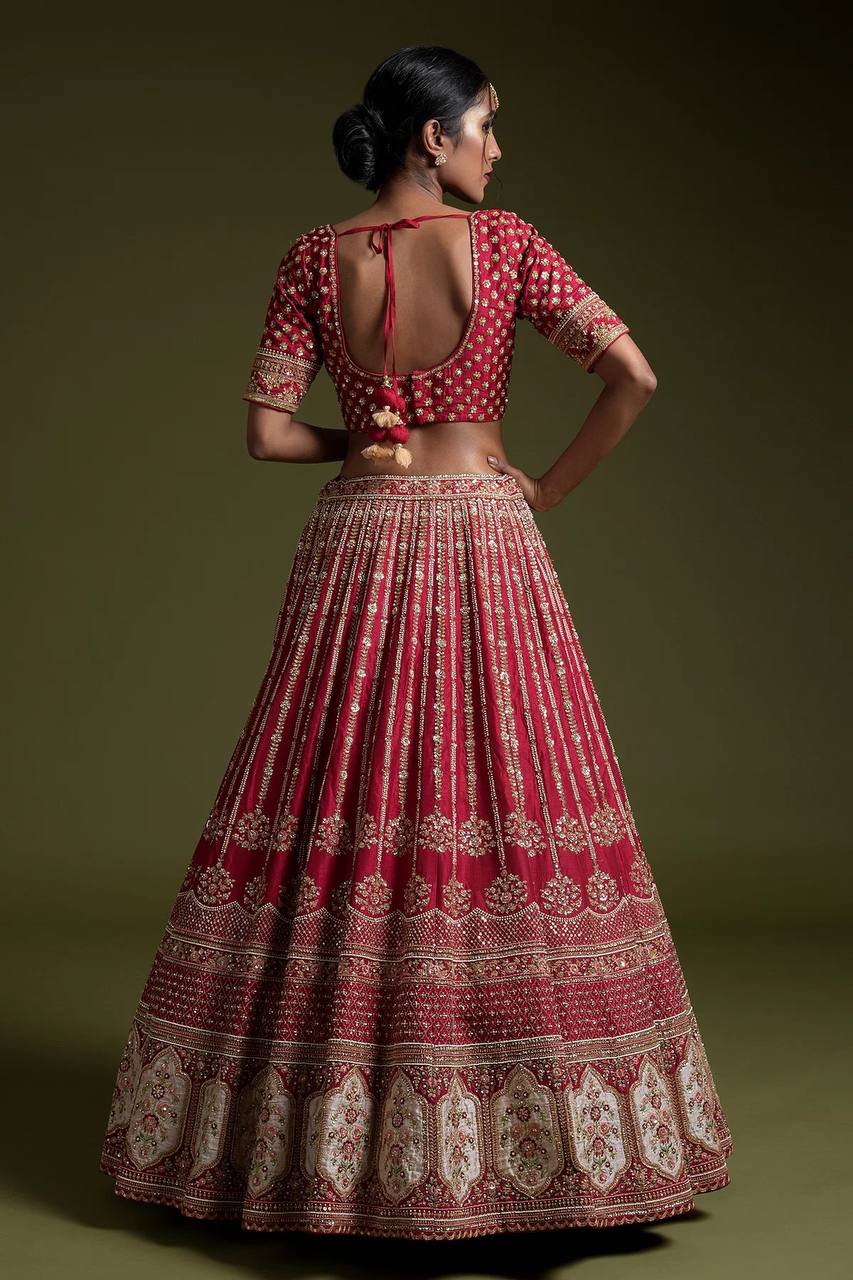 Elegant maroon lehenga with intricate thread work on blouse