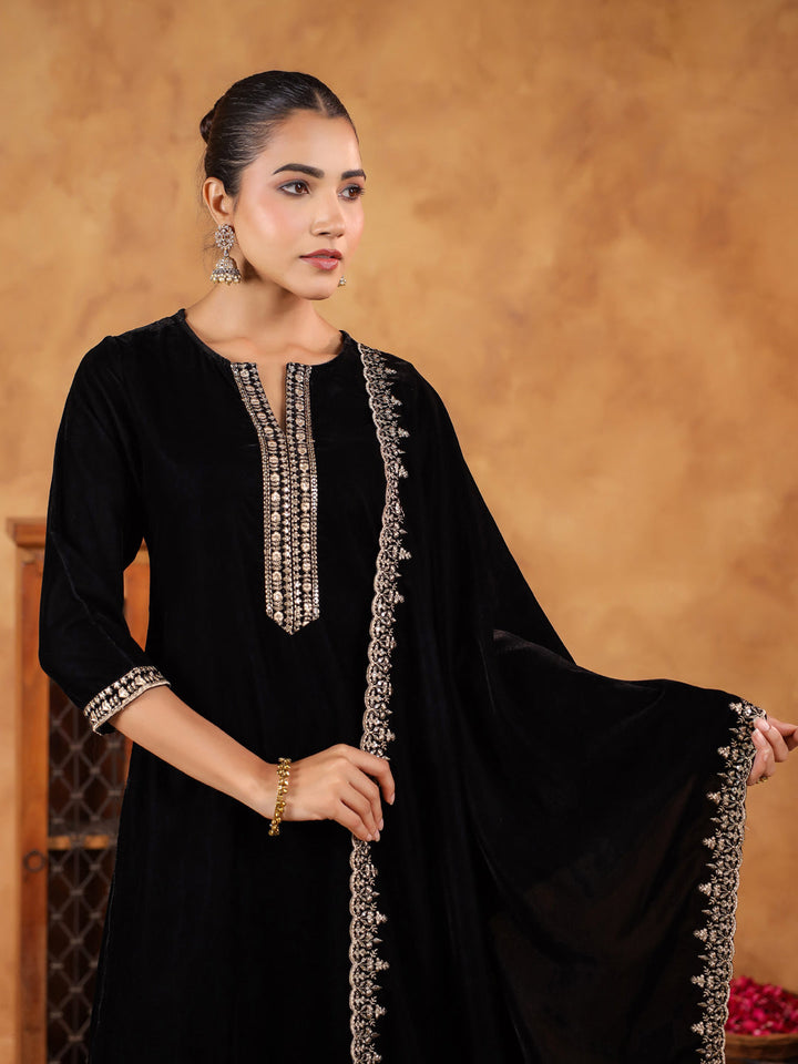 Fashionable black velvet kurta set with intricate zari work by Janasya