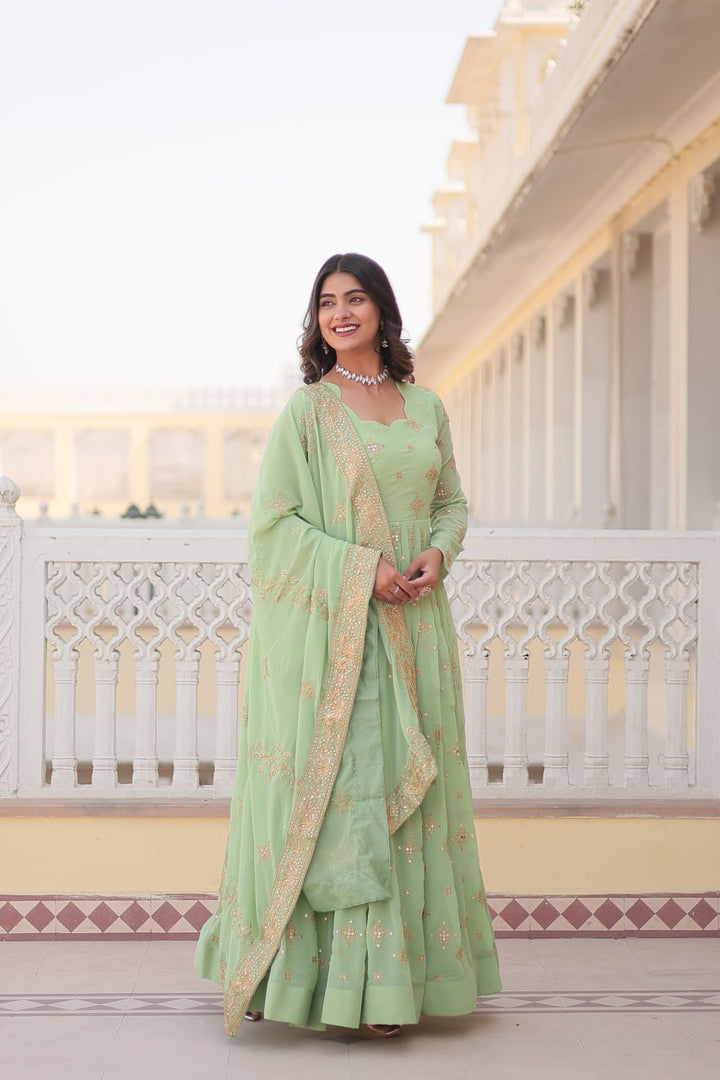 Pista green Georgette gown with intricate gold zari and sequins embroidery