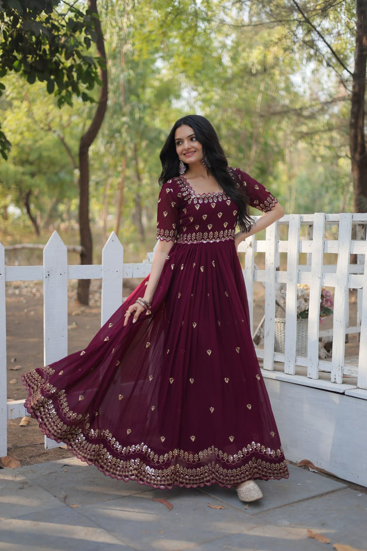 Beautiful wine-colored faux blooming fabric adorned with intricate embroidery, zari, and sequin work