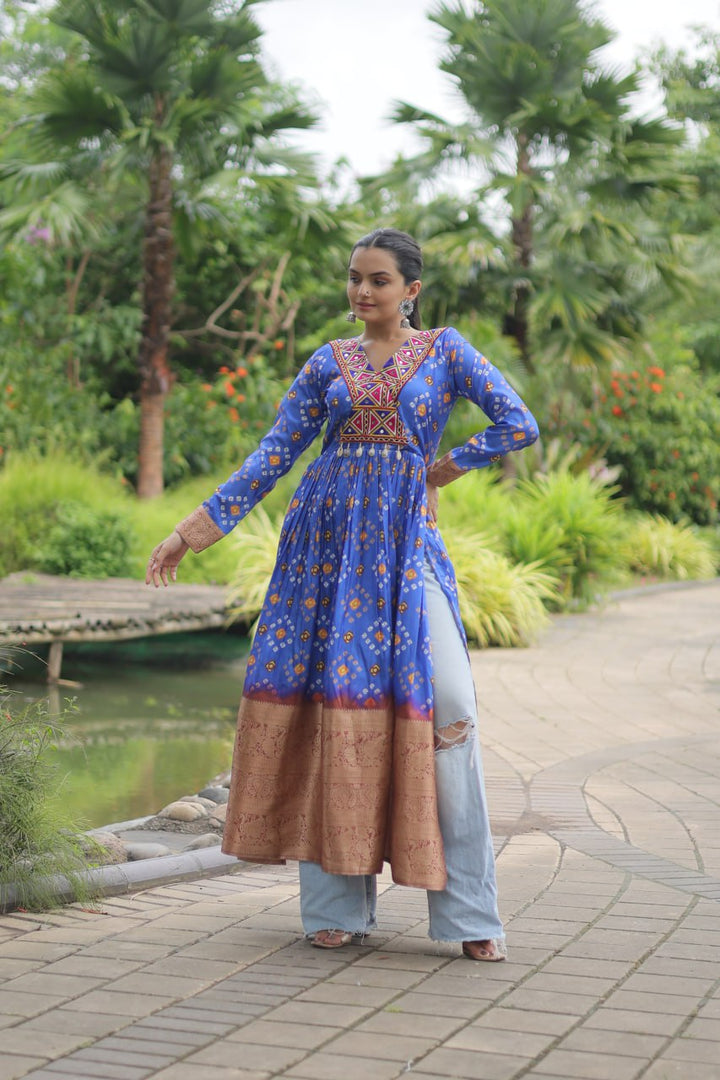 Close-up of beautifully crafted blue color printed cotton fabric with traditional Kutchi Gamthi work and delicate Kodi lace trim