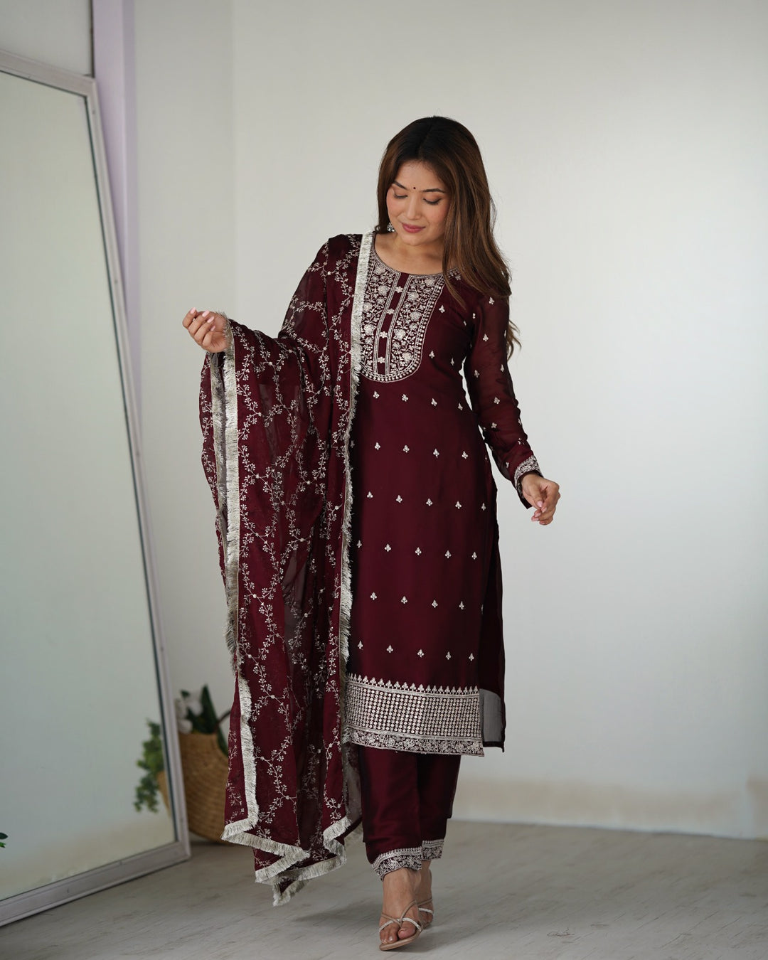 Traditional Indian salwar suit in deep wine color with detailed thread and sequin embellishments