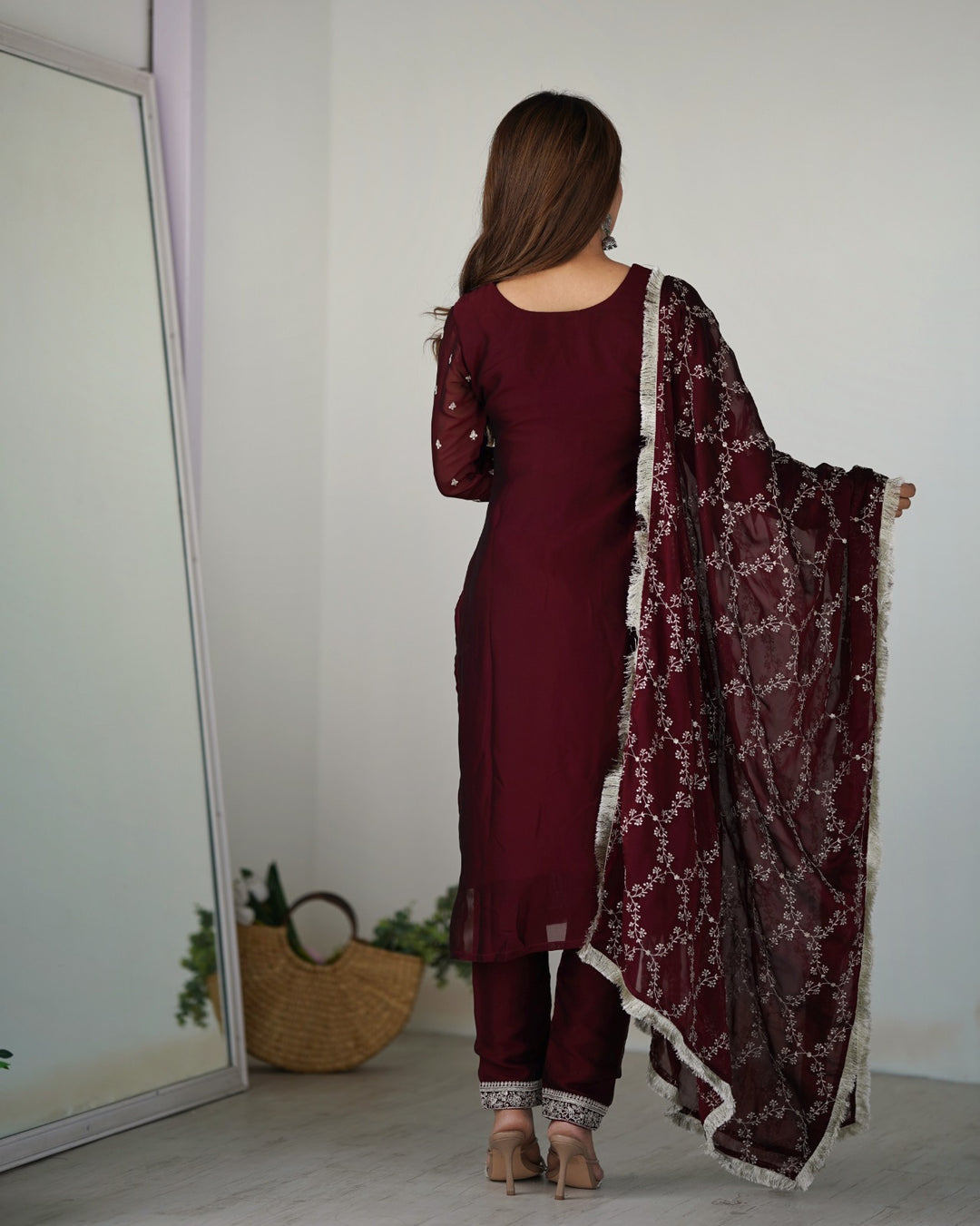 Exquisite wine colored salwar suit made from pure silk fabric adorned with beautiful embroidery and sequin work