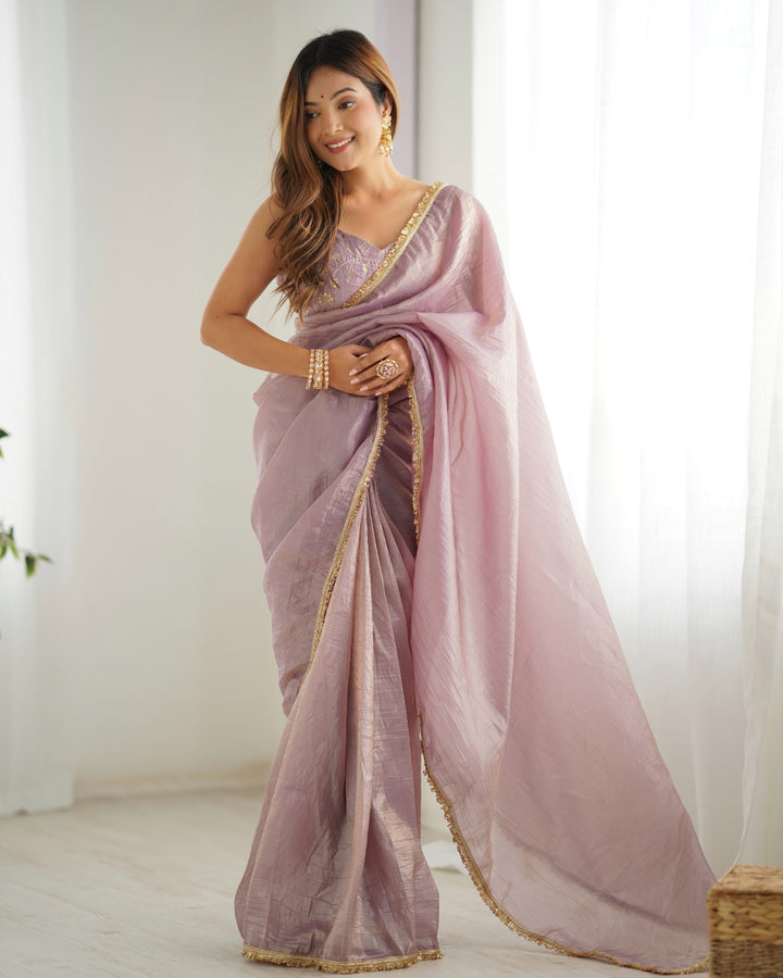 Light dusty mauve premium quality gold crush tissue silk fabric with fancy border premium lace work predrapped saree on display