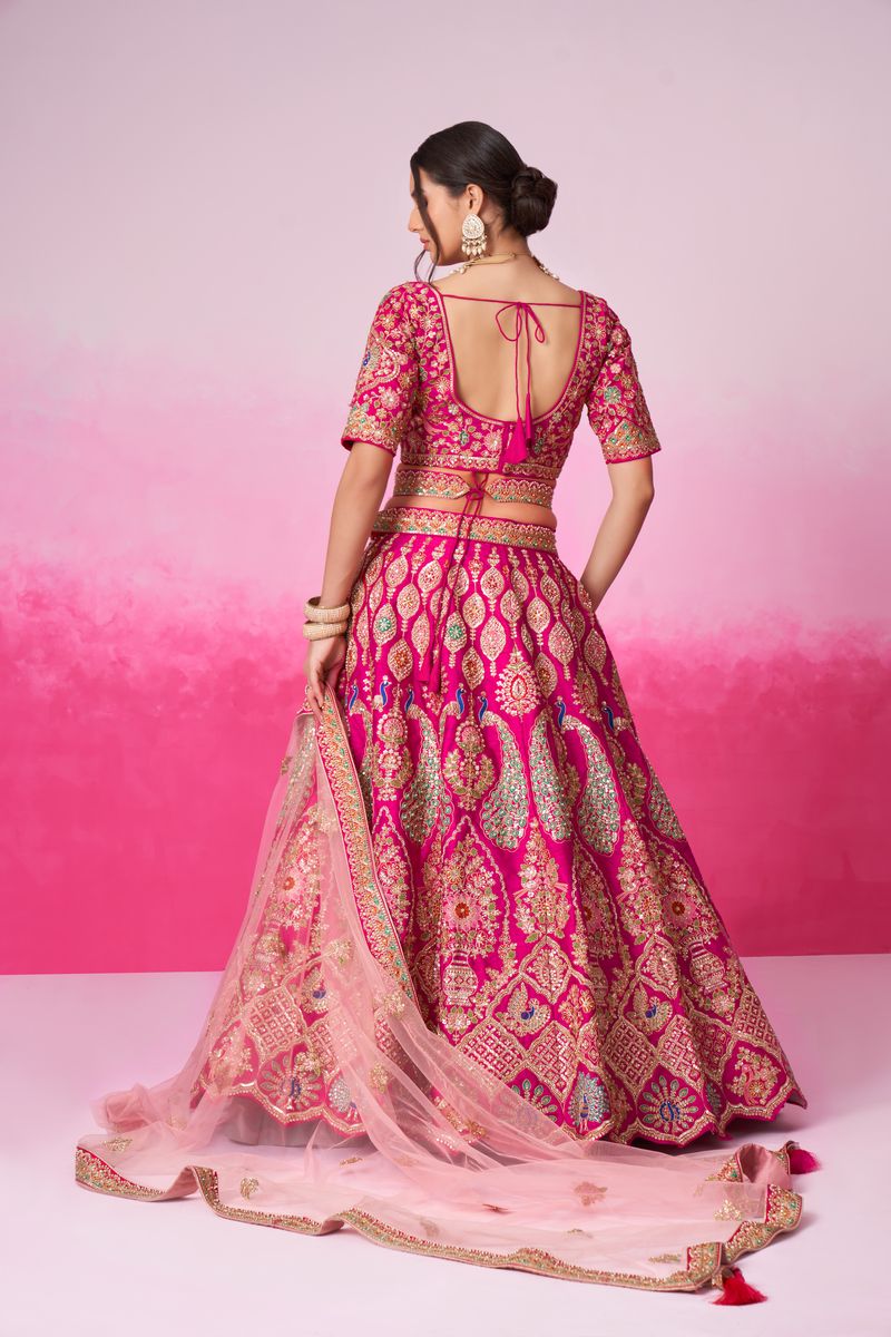 A beautiful pink silk bridal lehenga adorned with moti, sequins, and multicolor thread embroidery, accompanied by a double dupatta