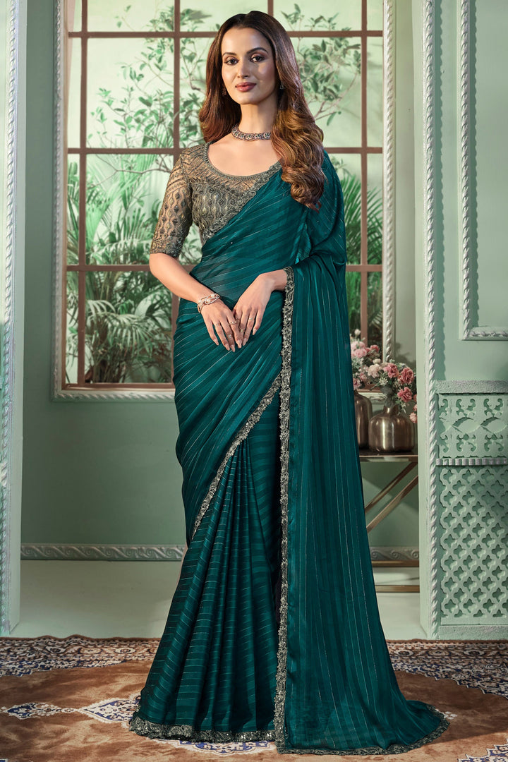 Dark green georgette fabric saree with intricate border work detail 