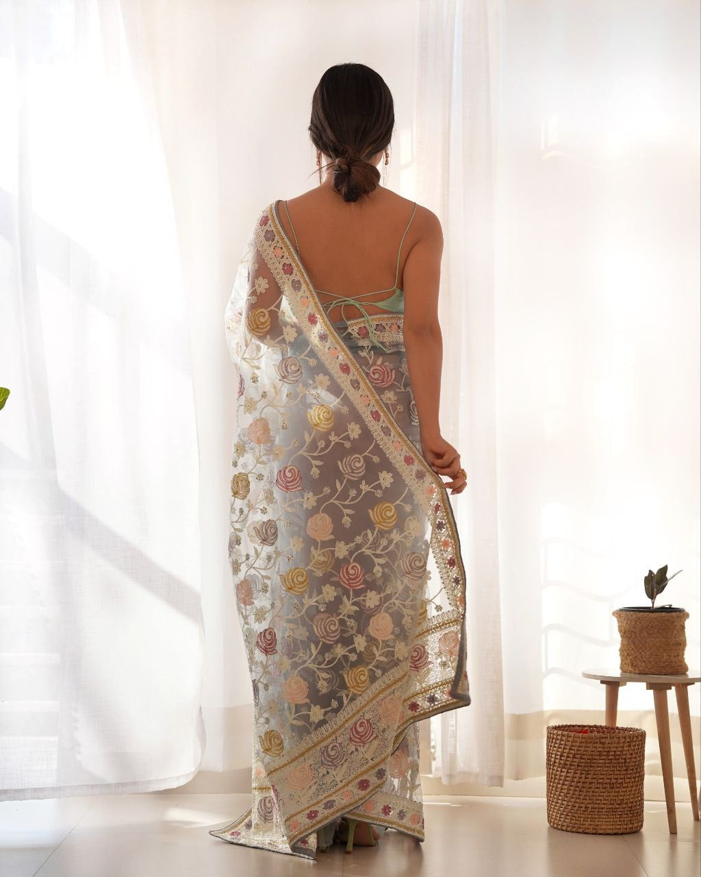 Silver colored saree featuring butterfly net malty color thread & aari embroidery work