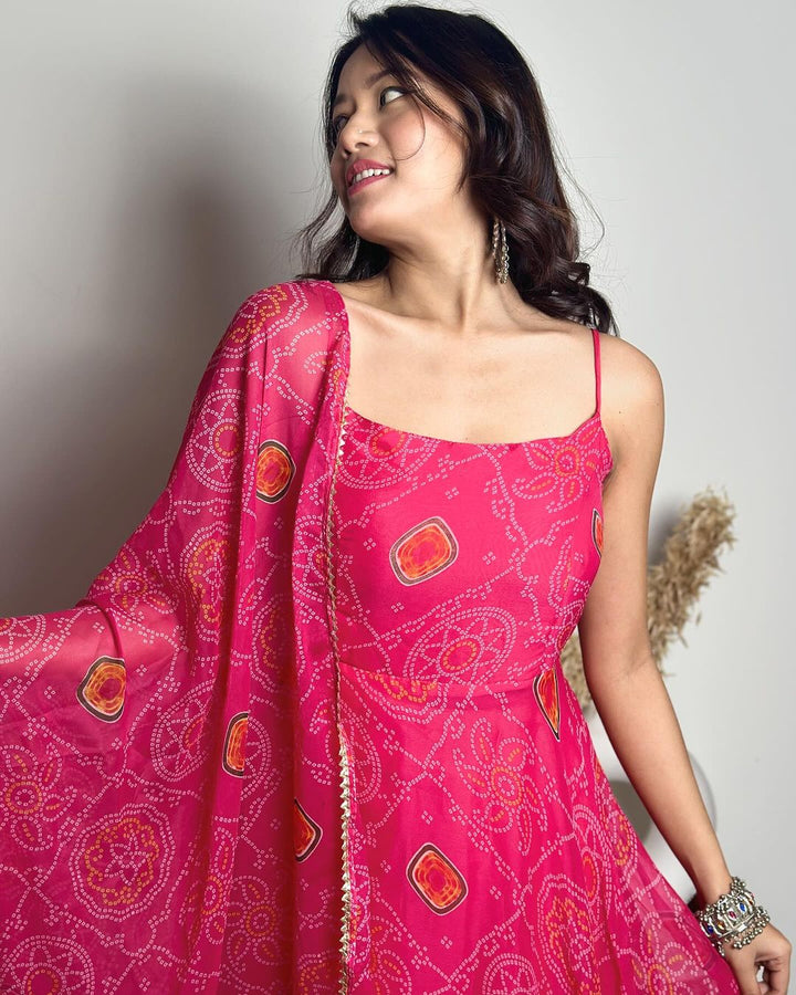 Enchanting pink color soft chiffon three piece Anarkali gown featuring intricate Bandhani print, a beautiful creation by Qivii for a fashionable and chic look