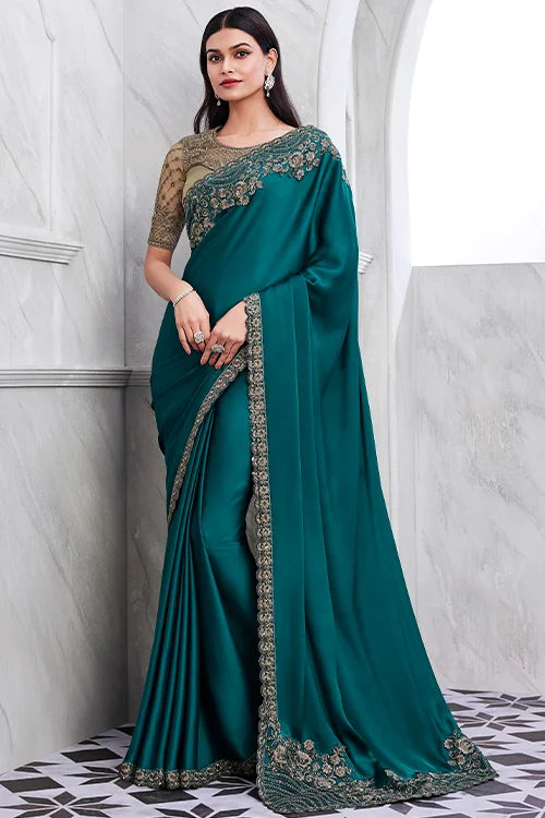 Teal blue designer walnut silk saree with intricate gold embroidery and matching blouse on mannequin