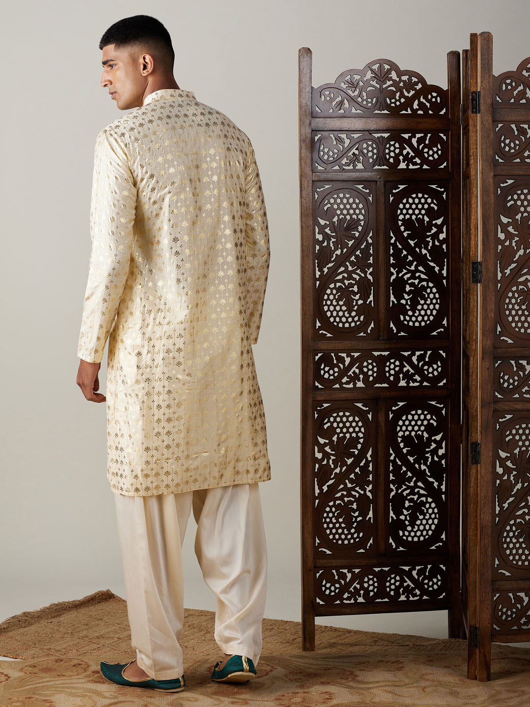  Close-up of intricate gold foil print on men's kurta