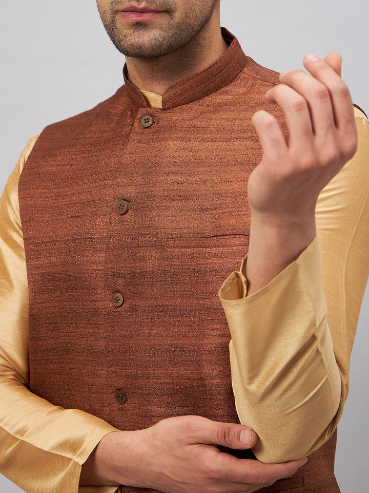 Elegant and stylish, the VM BY VASTRAMAY Men's Coffee Jacket With Rose Gold Kurta And Pant Set showcases a refined coffee jacket, complemented by a luxurious rose gold kurta and coordinating pants, ideal for special occasions and gatherings