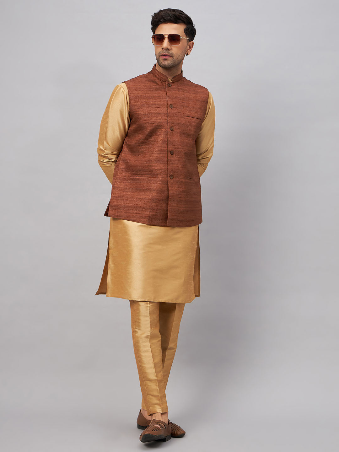  Handsome men's attire with a coffee jacket, rose gold kurta, and matching pants 