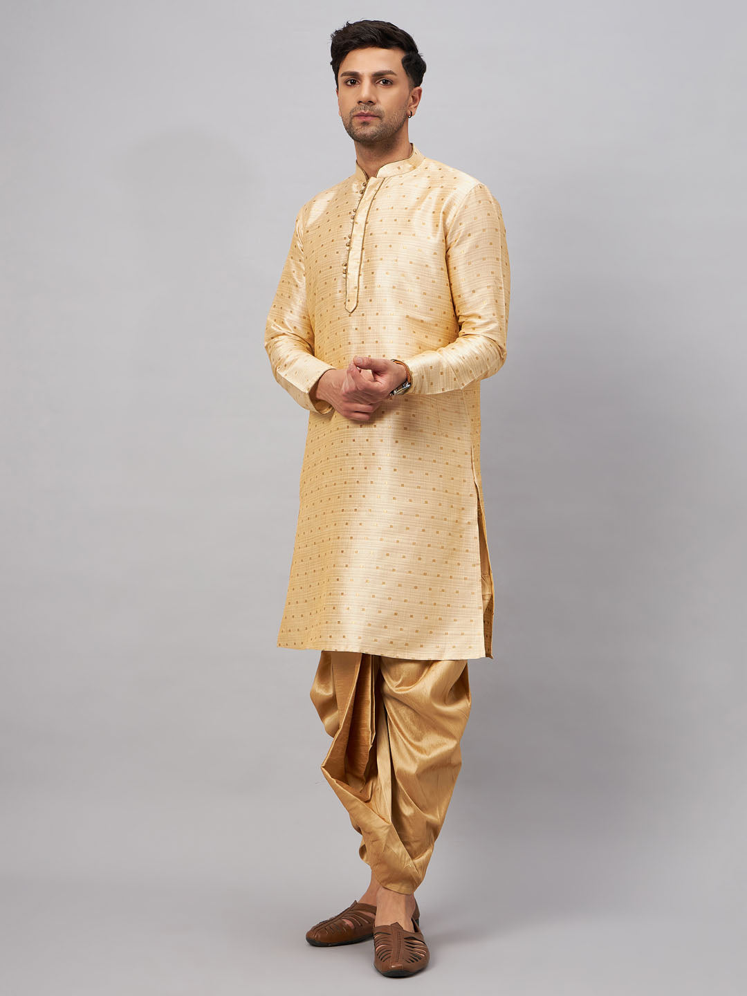 Detailed shot of the intricate zari work and pattern on the kurta and dhoti for men