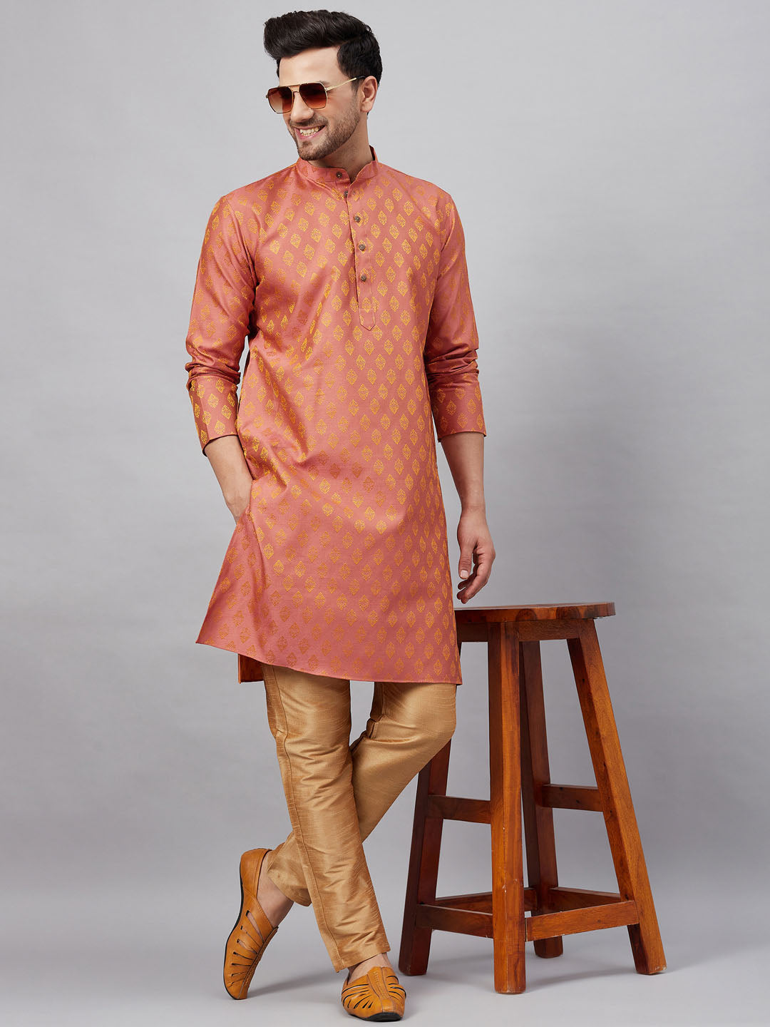 Traditional Indian men's outfit in pink and rose gold with elegant design