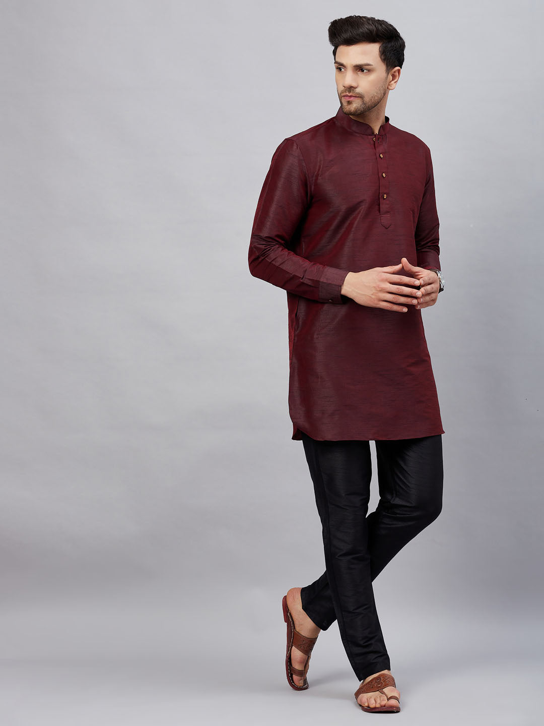 Elegant and stylish men's wine silk blend kurta pant set with a curved hemline and intricate detailing on the collar and cuffs