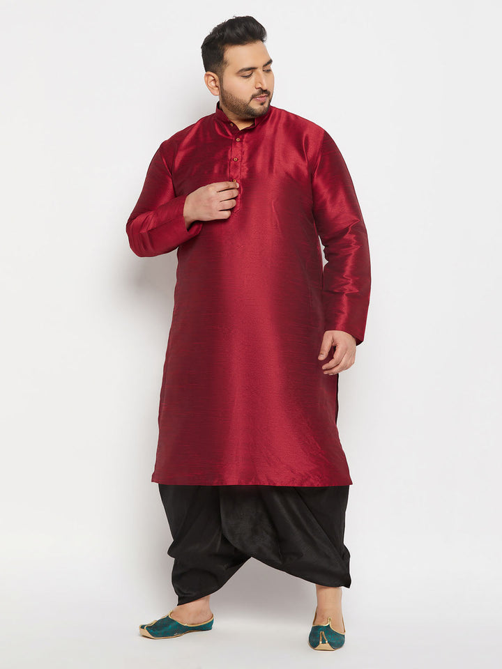  A man performing a traditional dance while wearing the VASTRAMAY Men's Plus Size Black Cotton Blend Solid Traditional Dhoti