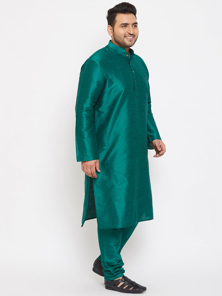 VASTRAMAY Men's Plus Size Green Silk Blend Kurta Pyjama Set worn by a smiling man standing in front of a traditional backdrop 